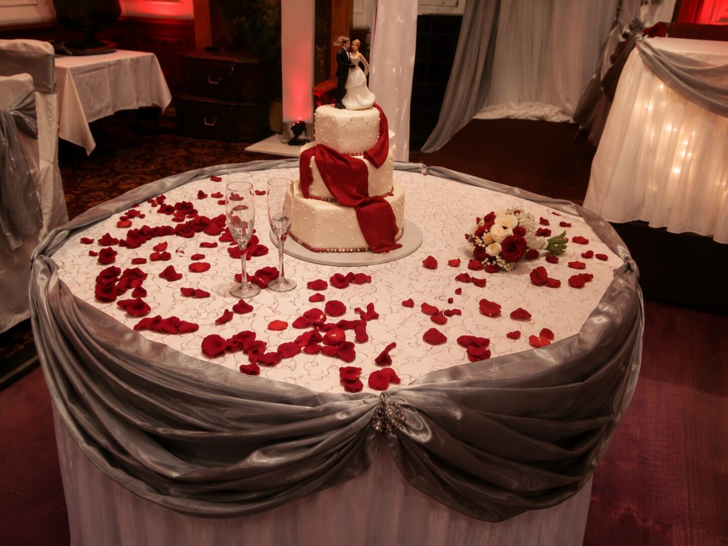 Wedding cake with red rose petals