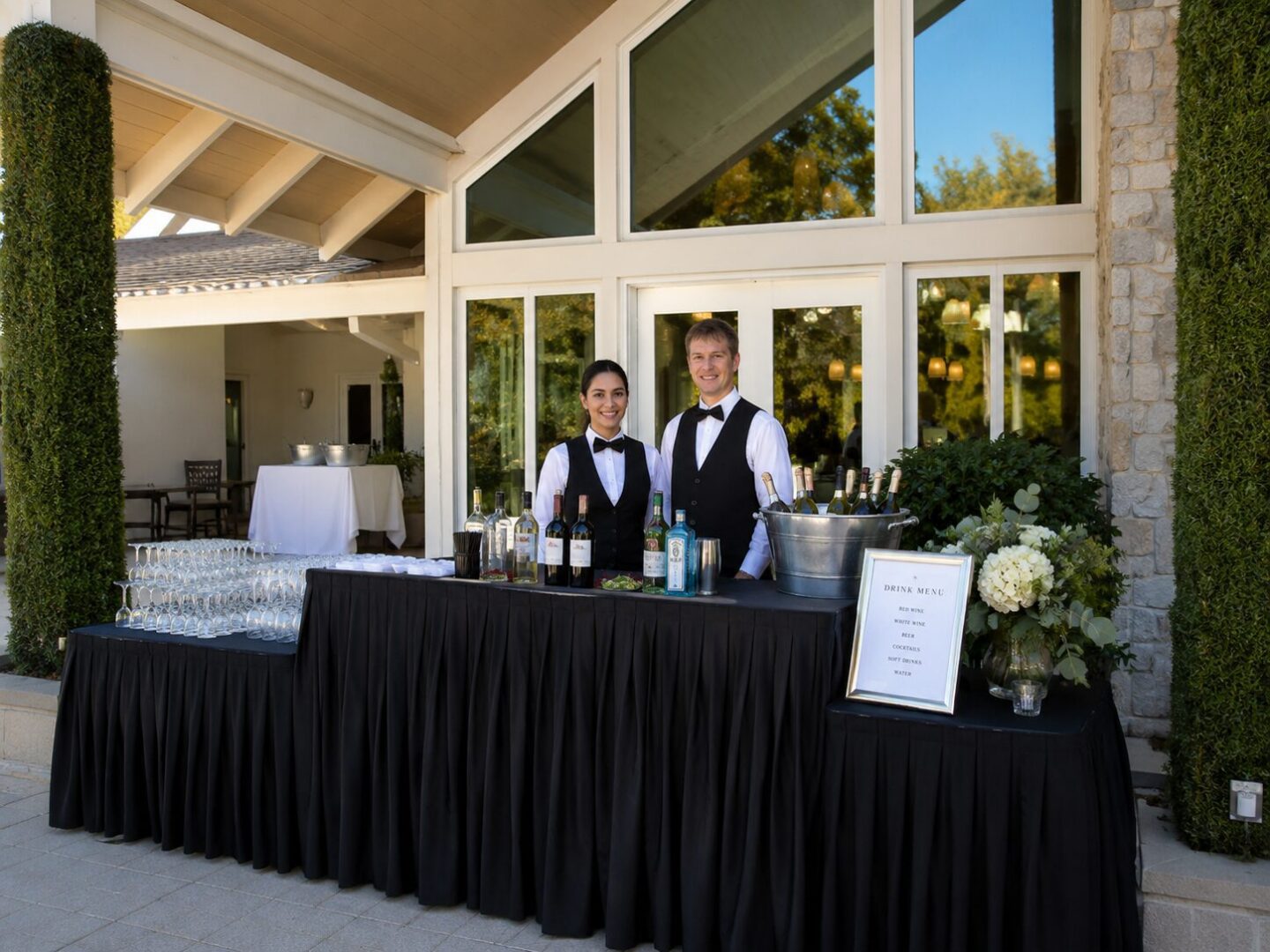 Elegant bar setup with drinks and flowers